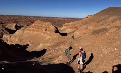 MQ expedition Altan Uul, Gobi Mongolia Quest Dinosaur Expedition participants walking along the ridge of Altan Uul in the Gobi Desert, enjoying the scenic landscape.
