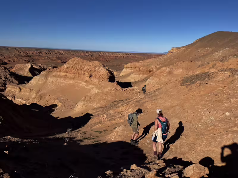 Mongolia Quest Dinosaur Expedition participants walking along the ridge of Altan Uul in the Gobi Desert, enjoying the scenic landscape.