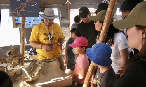 Mobile Museum guide giving information for visitors,Flaming Cliffs, 2023