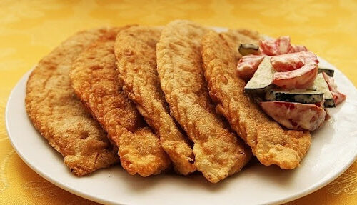 Khuushuur(Mongolian Traditional meal, deep fried dumpling) served with veggies.