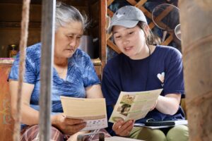 WCS Mongolia field staff engaging with a local herder woman to raise awareness about community-based conservation efforts in rural Mongolia.